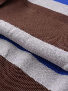 Macro shot of striped knit sweater with ribbed edges in navy blue, grey and brown