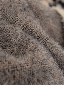 Close-up of soft brown-grey faux mink fur knit fabric with detailed plush texture