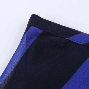 Detailed close-up showing stitching and dark blue diagonal stripes on chiffon midi skirt