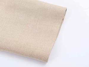 Macro della trama in maglia twill beige sul polsino per blazer da donna elegante