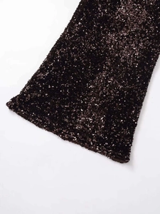 Detail shot of shimmering sequin fabric on a dark brown mini skirt with smooth inner lining