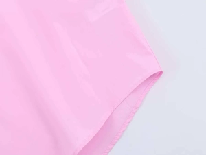 Detail of the light pink poplin shirt showing the rounded hem and fine flat-fell stitching