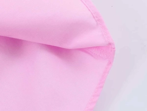 Detailed macro view of high-quality hem stitching on pink poplin cotton long sleeve shirt