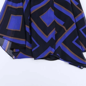 Detail of asymmetric chiffon hem featuring geometric block prints in navy and black