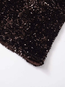 Detail view of deep coffee sequin fabric with metallic sheen and silky smooth lining