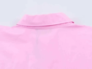 Detailed close-up of the crisp spread collar and fine stitching on the pink poplin shirt