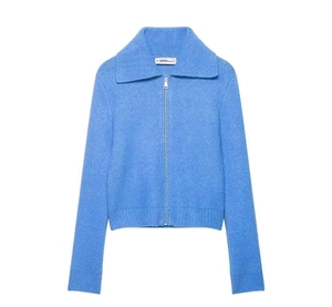 Detail view of the light blue knit cardigan featuring a silver zipper and wide lapel collar