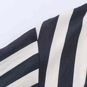 Detail shot of the fine vertical black and white striped fabric texture and cotton material