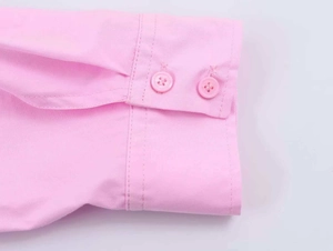 Detail shot of the pink poplin shirt cuffs featuring double buttons and precision stitching