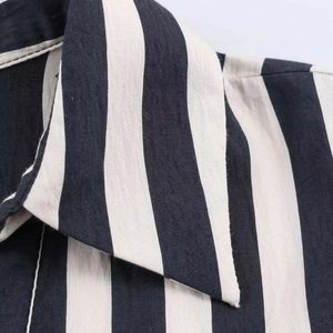 Macro detail of striped cotton-linen shirt collar with high-quality sewing craftsmanship