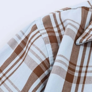 Detail of the high-quality shoulder seam stitching on this blue and brown plaid shirt