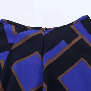 Detail view of the hidden back zipper on this geometric print asymmetric midi skirt