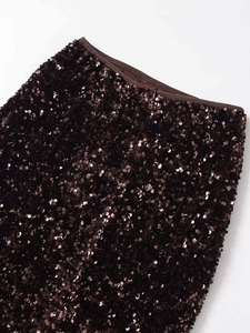 Detail of deep brown sequin mini skirt featuring a seamless hidden zipper and waist trim