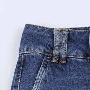 Detail of high-waist dark blue denim jeans with classic yellow stitching and belt loops