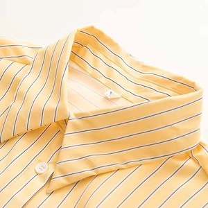 Detailed view of yellow and white striped shirt collar with size L label showing