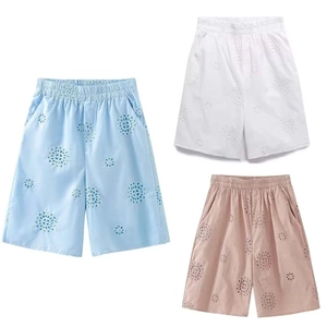 Detail of hollow embroidery on summer shorts in blue, white, and pink options