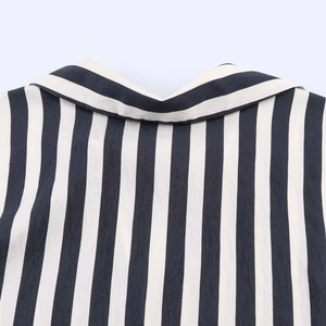 Detail of a black and white vertical striped shirt lapel collar with fine cotton texture