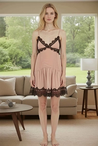 Detail view of pink satin slip dress with contrast black lace trim and V-neckline