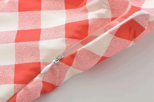 Detail of red gingham dress showing high-quality invisible zipper and neat stitching