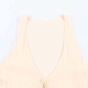 Detail of the V-neckline and rib-knit texture on a cream-colored midi summer dress