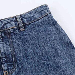 Detailed close-up of high-waist denim skirt featuring acid wash and yellow stitching