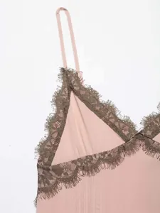 Detailed close-up of pink camisole with brown eyelash lace trim and fine vertical texture