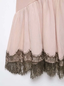 Detail shot of pale pink chiffon fabric with brown eyelash lace trim and fine textures