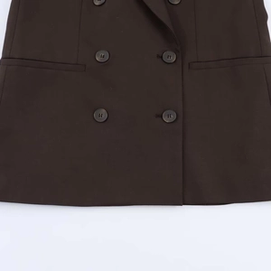 Détails rapprochés des boutons du blazer marron foncé à double boutonnage et poches