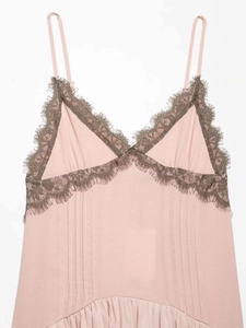 Macro detail of V-neck lace trim and pleated pink vintage camisole slip dress