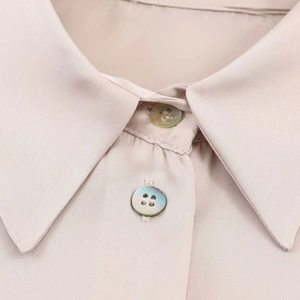 Elegant champagne satin shirt featuring a classic collar and pearl-like buttons detail