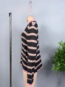 Macro detail of casual striped knit sweater with pink collar and ribbed cuffs