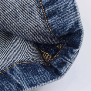 Close-up of dark blue denim skirt featuring premium orange contrast stitching details