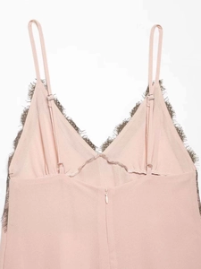 Detail of light pink V-neck top featuring dark grey eyelash lace trim and adjustable straps