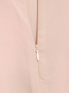 Detail shot of a concealed pink zipper on delicate summer lace dress fabric