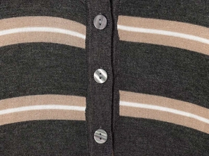 Close-up of striped knit cardigan showing marble-textured buttons and fabric detail