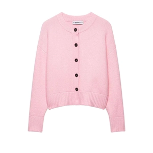 Minimalist pink knit cardigan with contrasting black buttons and classic round neckline