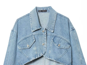 Close-up of internal brand label and size tag on a light blue cropped denim jacket