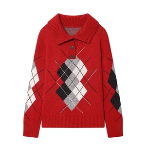 Klassischer roter Strick-Polo-Pullover mit schwarz-weißen Argyle-Rauten auf weißem Hintergrund