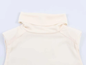 Detail of high neck and smooth sleeveless shoulder cut on this off-white summer vest