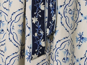 Dettaglio ravvicinato del tessuto floreale blu con cintura coordinata per abiti estivi
