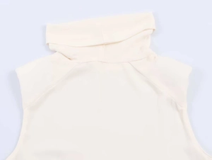 Detail shot of the mock neck design and pleated folds on a cream sleeveless knit top