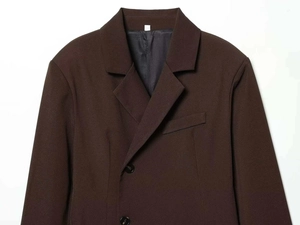 Detail of notch lapel and dark brown twill fabric on a loose tailored suit jacket