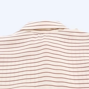 Detail view of the fine red stripes on a creamy white casual shirt with neck collar
