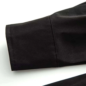 Detail shot of black long sleeve cuff with high-quality stitching and cotton fabric