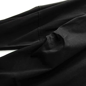 Detail of premium black fabric texture and clean stitching on this V-neck wrap dress