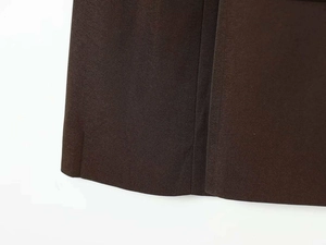 Detailed macro view of deep brown twill fabric texture and high-quality suit material