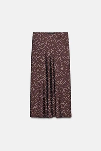 Detailed view of dark brown polka dot satin skirt with soft lustrous fabric texture