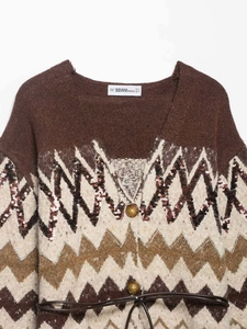 Detail of V-neck jacquard cardigan with sequin trim, amber buttons and leather belt