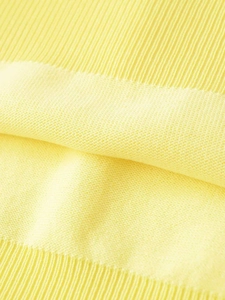 Close-up detail of soft bright yellow knit fabric texture and fine ribbed knitting patterns