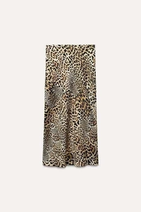 Detail shot of long satin skirt featuring classic leopard print and smooth texture